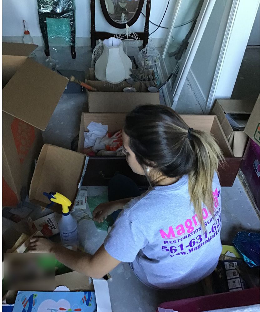 Magnolia technician sorting and packing household contents into boxes
