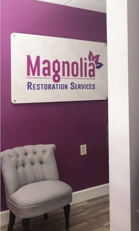 Magnolia Restoration Services sign in the office
